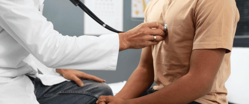 Doctor using stethoscope on patient