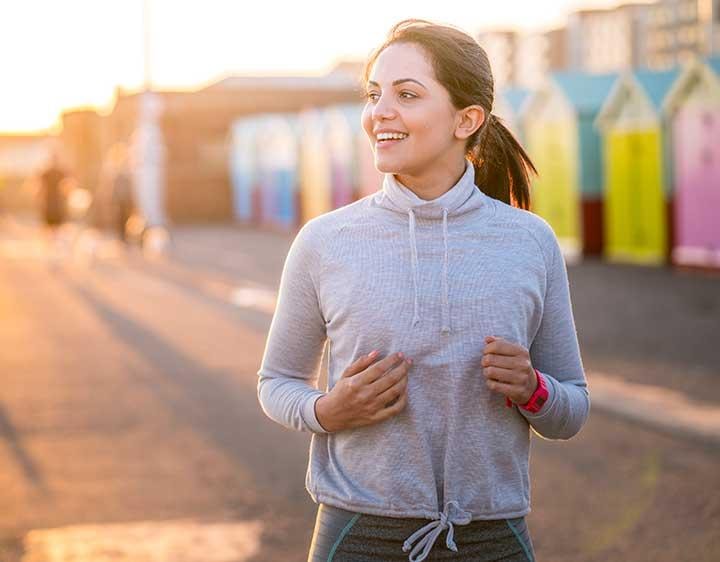 Woman jogging outdoors at sunset